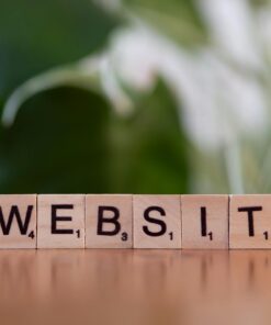 Scrabble tiles on a wooden surface forming the word 'Website', symbolizing digital communication.